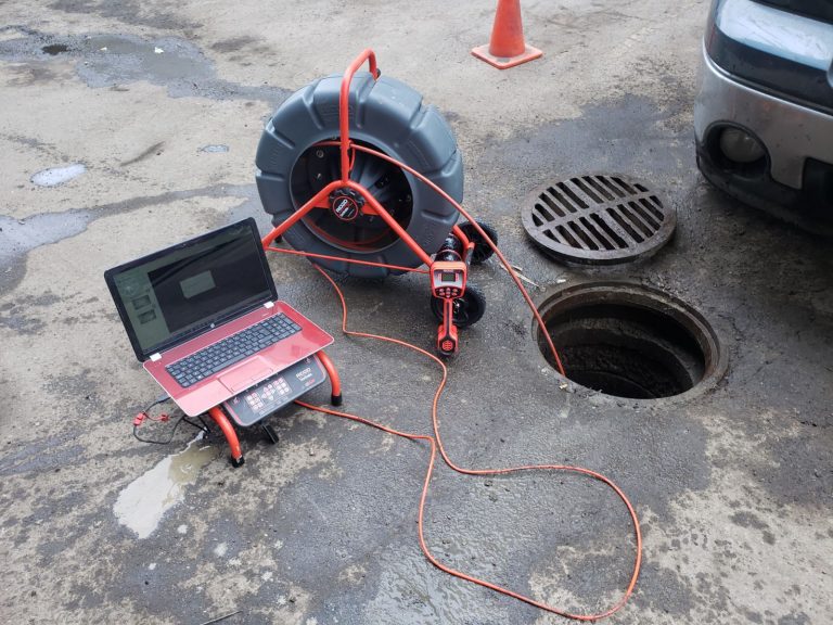 Sewer inspection camera scoping down city manhole