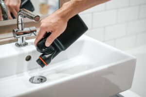 drain-cleaner-being-poured-down-sink