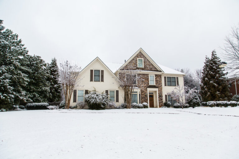 large-white-and-brown-brick-home-with-snowy-front-lawn