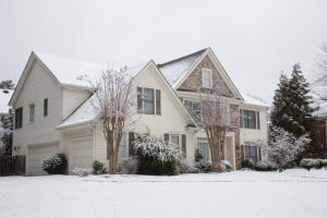 Large home covered in snow after winter storm