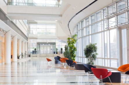 Bright corporate lobby with modern seating, highlighting commercial drain maintenance services for office buildings.”