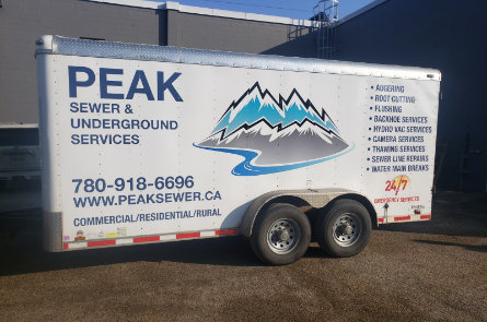Peak Sewer & Underground Services trailer used for sewer, hydrovac, and underground utility services.