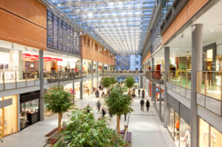 Bright shopping mall atrium illustrating high-traffic commercial spaces needing professional drain cleaning.